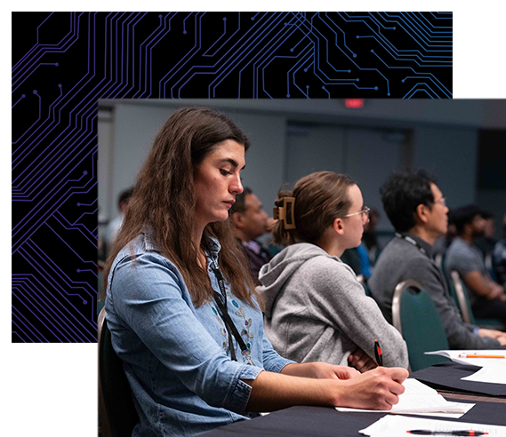 Woman takes notes as she listens to a DesignCon speaker.