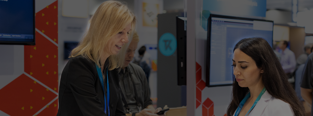 Exhibitor showing product to an attendee at her booth