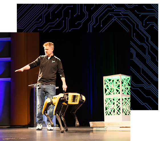 Boston Dynamics’ Devin Billings and Spot the mobile robot on stage during a keynote address.