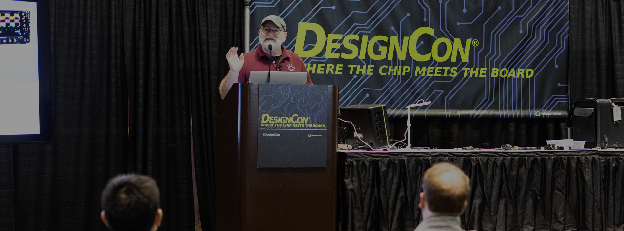Speaker at a podium presenting to an audience