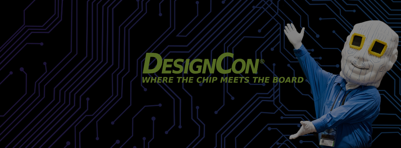 Chiphead mascot stands next to DesignCon sign to welcome people