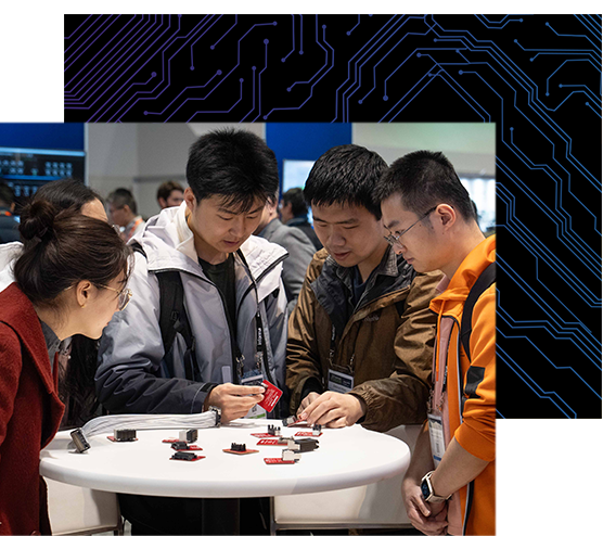 4 attendees inspect semiconductor chips at DesignCon.