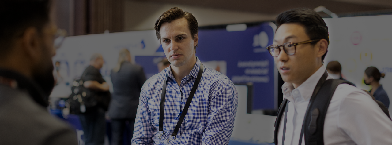 Attendees listening to an exhibitor at the expo